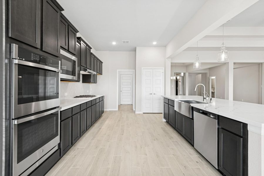 Stunning kitchen with dark stain cabinets and quartz counters Stunning kitchen with dark stain cabinets and quartz counters