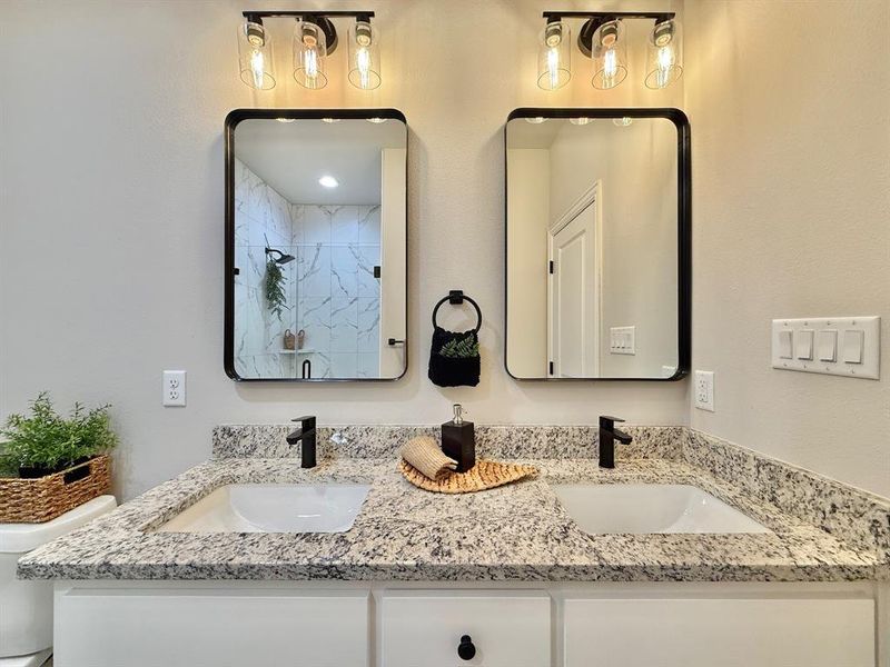 Bathroom featuring vanity and a shower