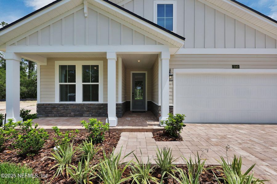 Front exterior of a new home in Creighton Pointe, Fleming Island, FL, highlighting curb appeal (Image 1). Front exterior of a new home in Creighton Pointe, Fleming Island, FL, highlighting curb appeal (Image 1).