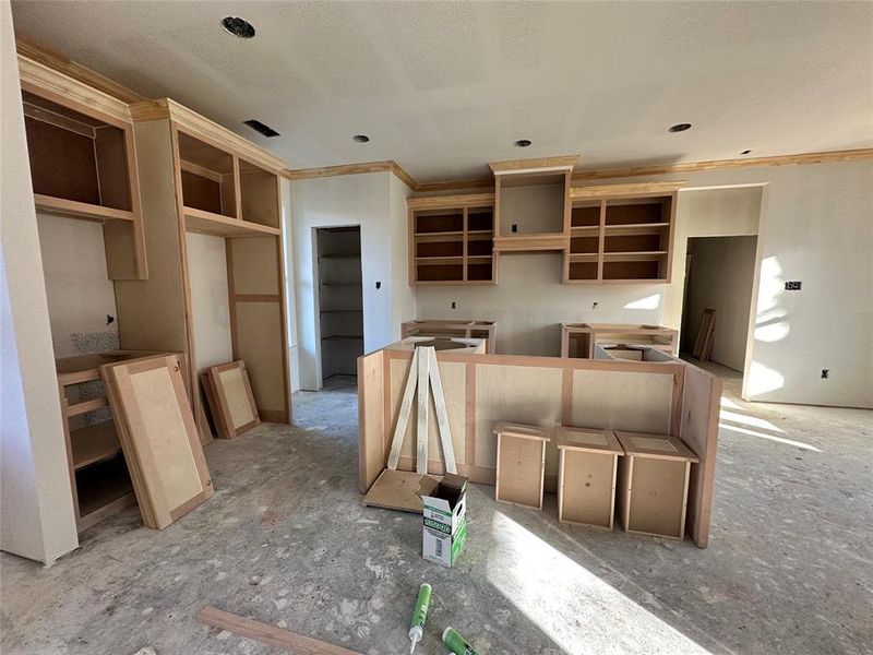 Kitchen with light brown cabinets and ornamental molding