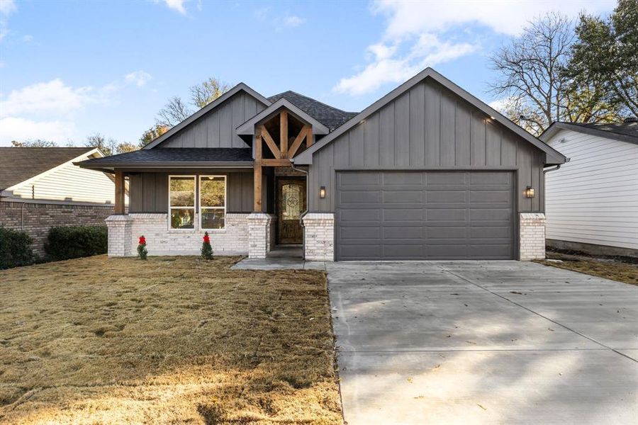 View of front of home featuring a garage and a front lawn