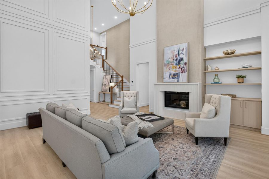 A stunning fireplace with textured surround serves as the focal point of the living area, complemented by custom shelving and cabinetry designed for both style and functionality. A stunning fireplace with textured surround serves as the focal point of the living area, complemented by custom shelving and cabinetry designed for both style and functionality.