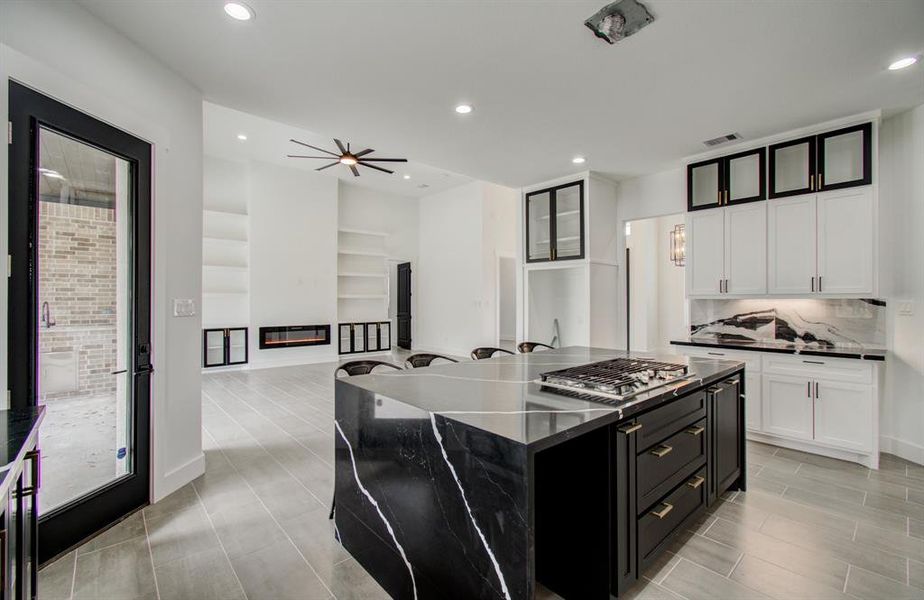 SIDE VIEW OF THE KITCHEN ISLAND AND LIVING ROOM