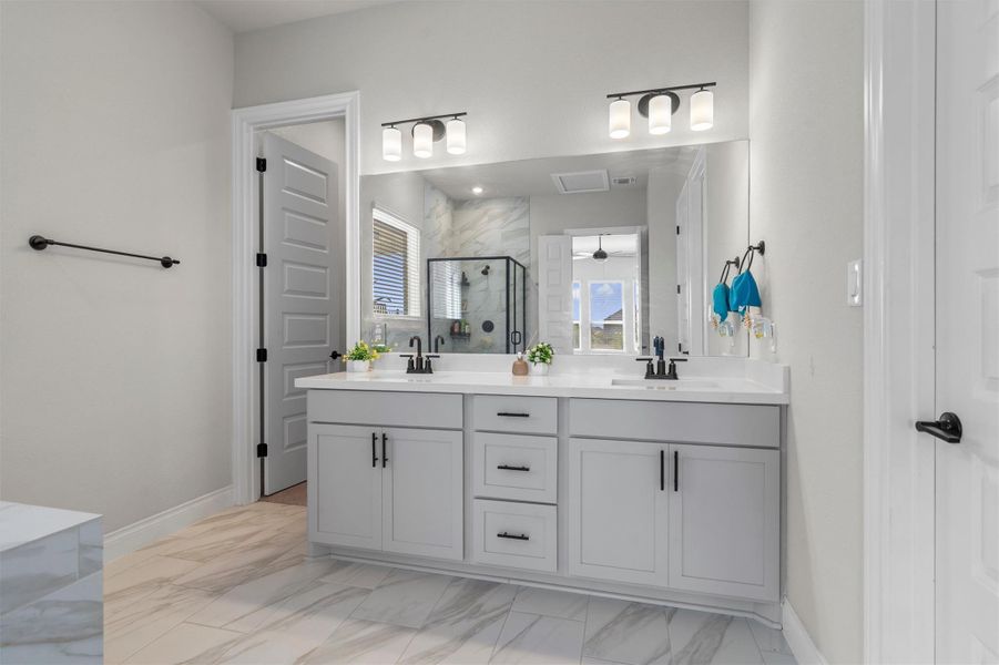 Clean lines and stone tile flooring define this contemporary double vanity bath.