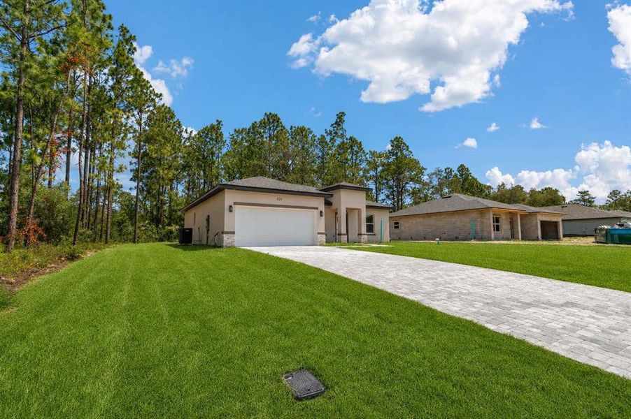 Front exterior of a new home in , Citrus Springs, FL, highlighting curb appeal (Image 16). Front exterior of a new home in , Citrus Springs, FL, highlighting curb appeal (Image 16).
