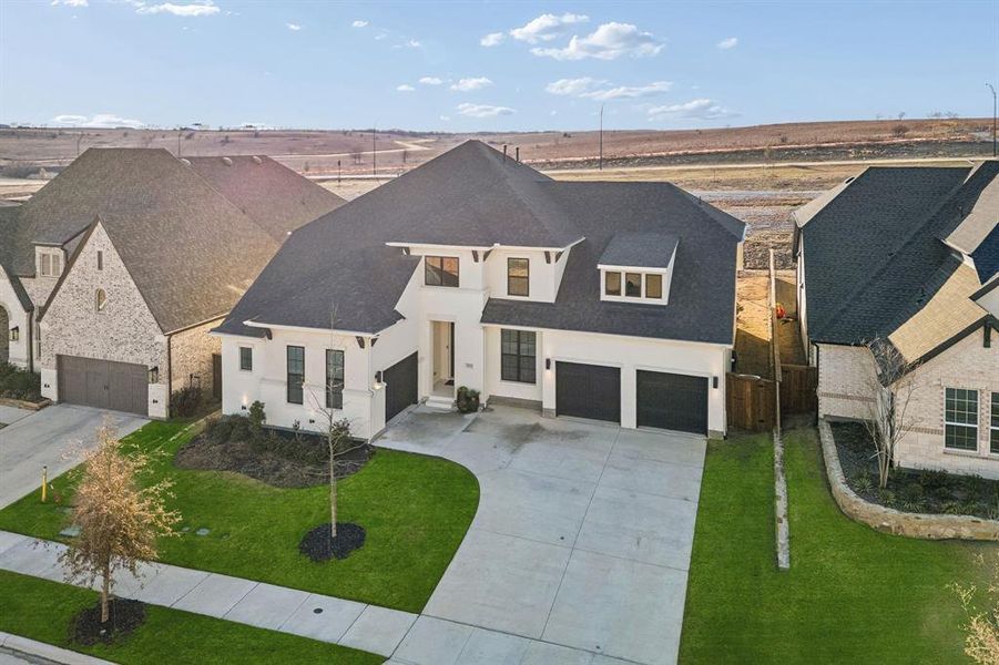 Front exterior of a new home in Walsh Ranch 70', Fort Worth, TX, highlighting curb appeal (Image 24). Front exterior of a new home in Walsh Ranch 70', Fort Worth, TX, highlighting curb appeal (Image 24).