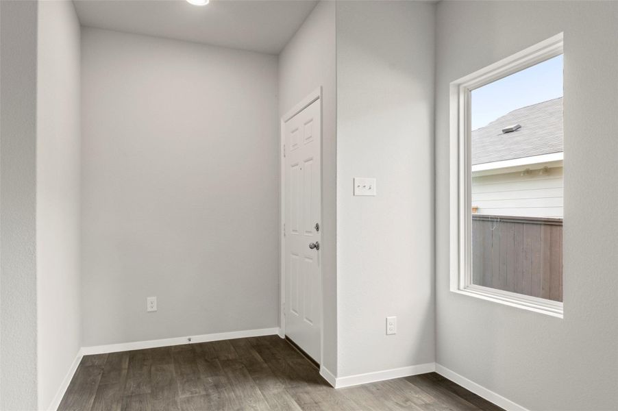 Foyer entrance with wood finished floors and baseboards