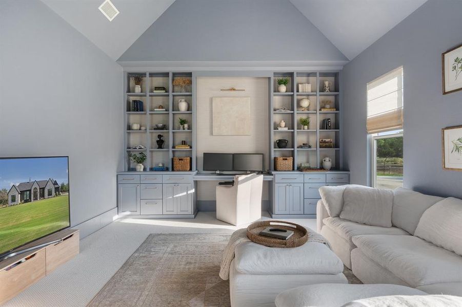 Living room with carpet and high vaulted ceiling