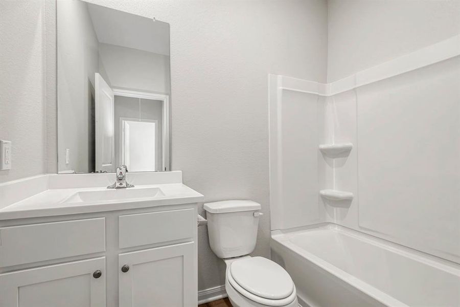 The secondary bathroom, located centrally in the hallway of the home.