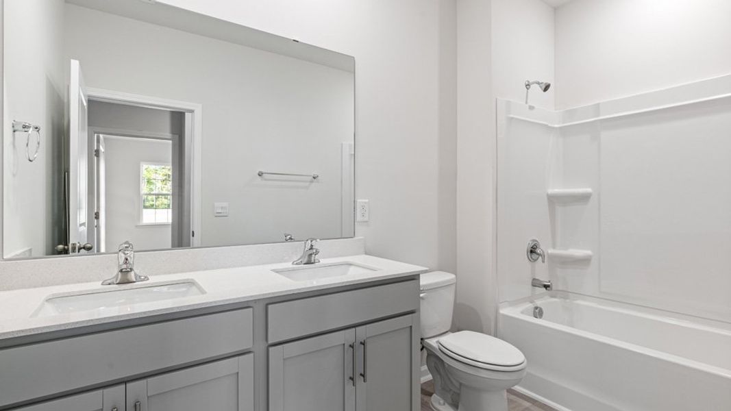 Representative furnished interior of a home built from the Booth by D.R. Horton in River Stone, Elm City (Image 5).