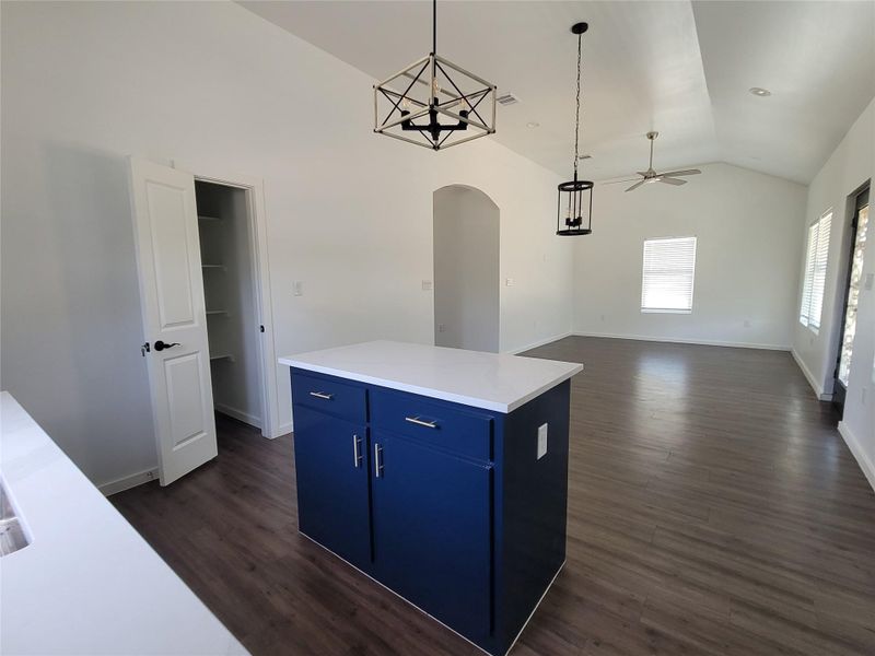 A well-lit, open-concept living space with sleek flooring and modern light fixtures.