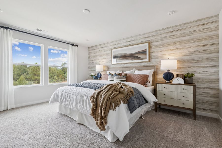 A bedroom with a bed and a window. A bedroom with a bed and a window.