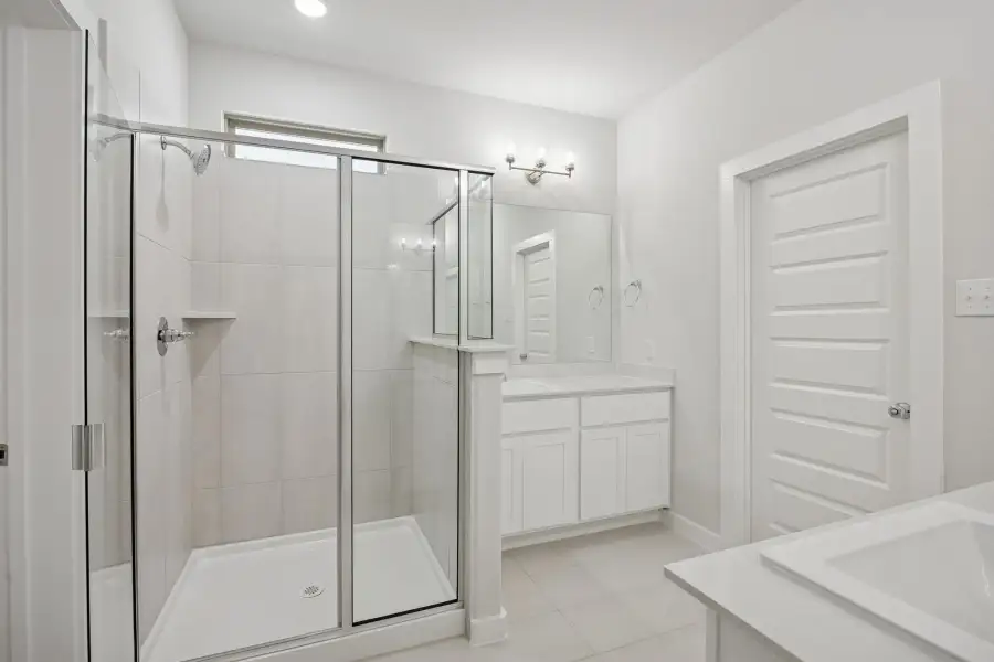 Primary Bathroom in the Masters home plan by Trophy Signature Homes – REPRESENTATIVE PHOTO