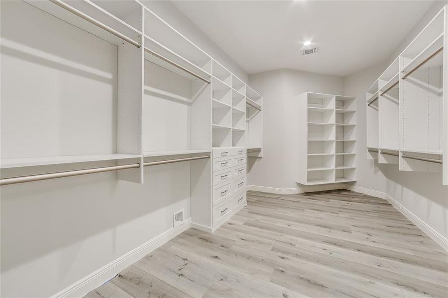 Primary Bedroom Spacious Closet with tons of built ins.  Truly a custom closet!