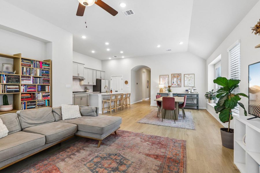 An open-concept living space integrates a well-appointed kitchen and dining area.