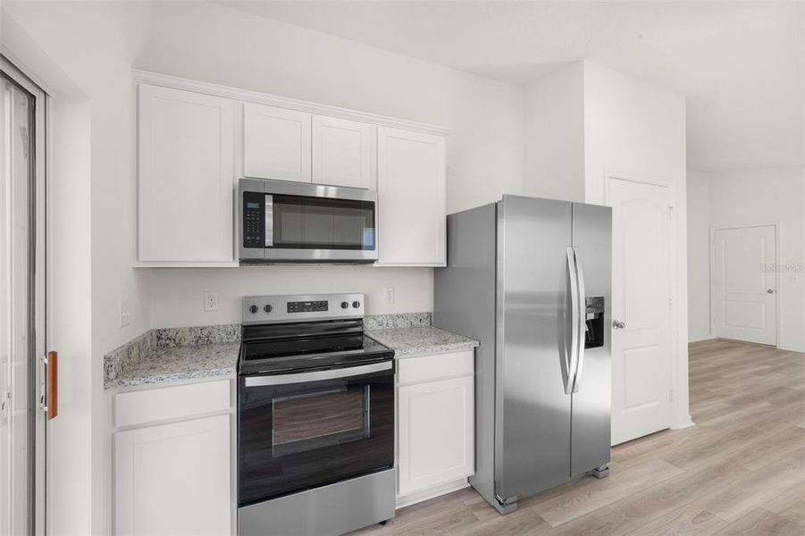 Furnished interior view inside a new home in Tula Parc, Astatula (Image 7).