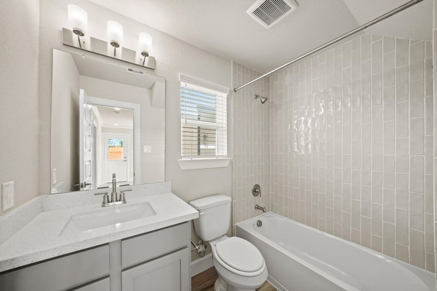 Hall bath (*Photo not of actual home and used for illustration purposes only.)Charming dining area (*Photo not of actual home and used for illustration purposes only.)Lovely kitchen (*Photo not of actual home and used for illustration purposes only.)Stylish kitchen (*Photo not of actual home and used for illustration purposes only.)Serene primary suite (*Photo not of actual home and used for illustration purposes only.)Primary bath with dual sinks, tub, and separate shower (*Photo not of