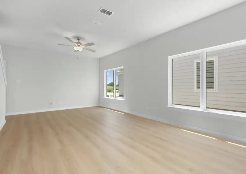 The open living room has large windows for natural light.
