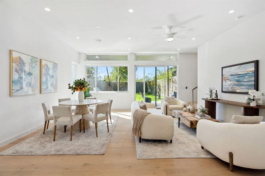 Living area featuring light wood-type flooring, recessed lighting, and a ceiling fan