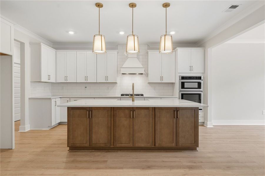 A spacious kitchen with an inviting island and ove