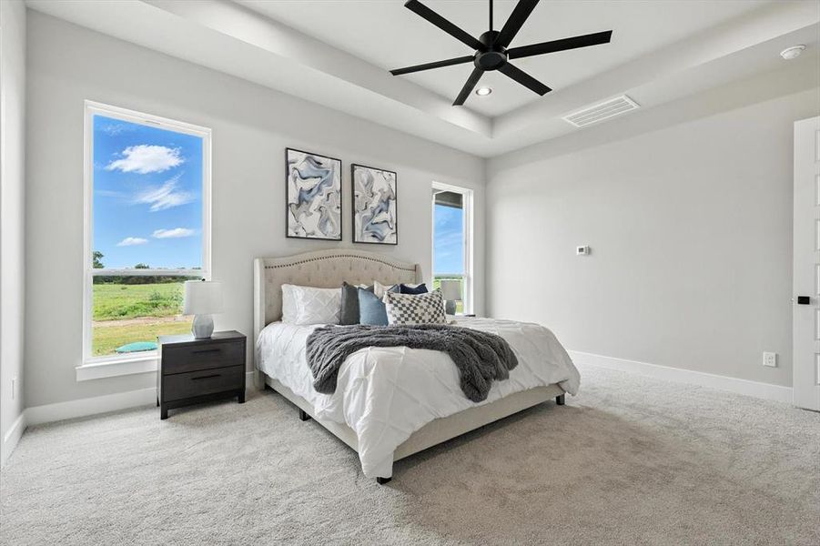 Carpeted bedroom with recessed lighting, multiple windows, a raised ceiling, and ceiling fan Carpeted bedroom with recessed lighting, multiple windows, a raised ceiling, and ceiling fan