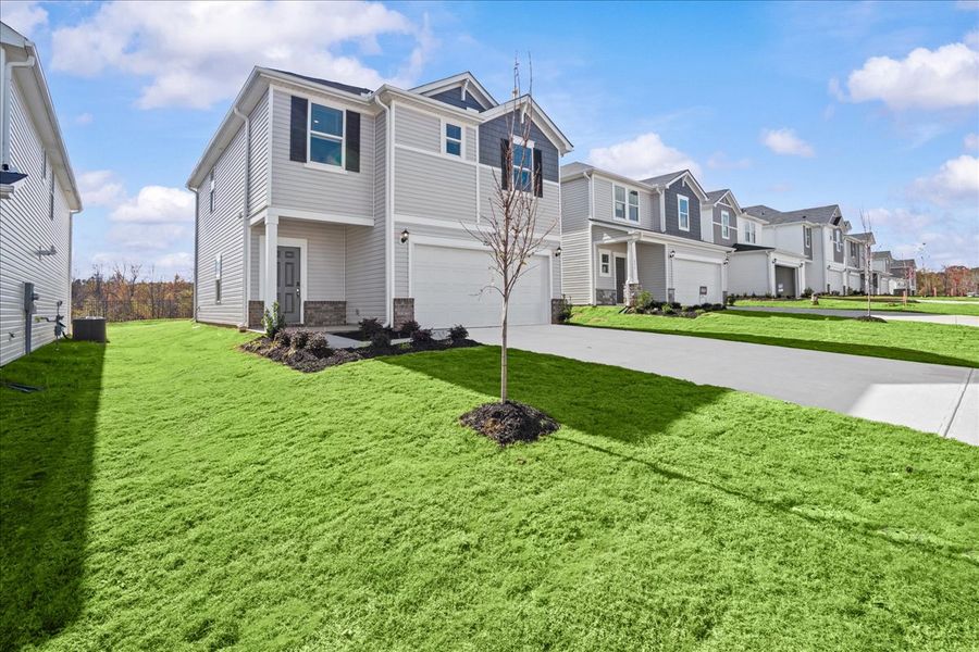 Front exterior of a new home in Creek Ridge - Heritage Collection, Spartanburg, SC, highlighting curb appeal (Image 2). Front exterior of a new home in Creek Ridge - Heritage Collection, Spartanburg, SC, highlighting curb appeal (Image 2).