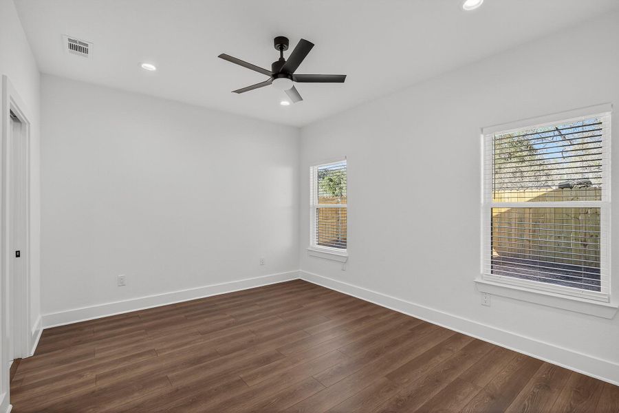 Unfurnished room with dark wood-type flooring, recessed lighting, and a ceiling fan Unfurnished room with dark wood-type flooring, recessed lighting, and a ceiling fan