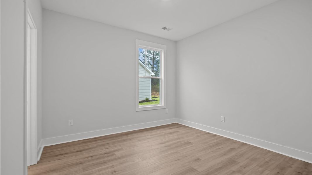 Desirable hardwood flooring in all bedrooms creates a cohesive and elegant interior