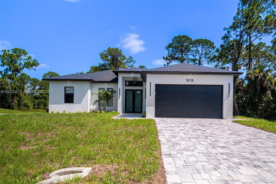 Front exterior of a new home in , Lehigh Acres, FL, highlighting curb appeal (Image 2). Front exterior of a new home in , Lehigh Acres, FL, highlighting curb appeal (Image 2).