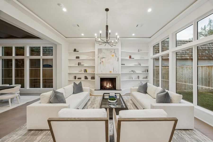 Family Room with a Montigo DelRay 42" Gas Fireplace with Cast Stone Surround. There is Built-In Curved Shelving a Candle Style Chandelier. Family Room with a Montigo DelRay 42" Gas Fireplace with Cast Stone Surround. There is Built-In Curved Shelving a Candle Style Chandelier.