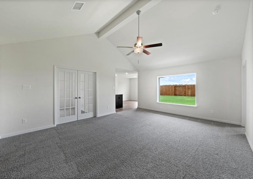 The spacious family room has a large window with great natural light and backyard views.