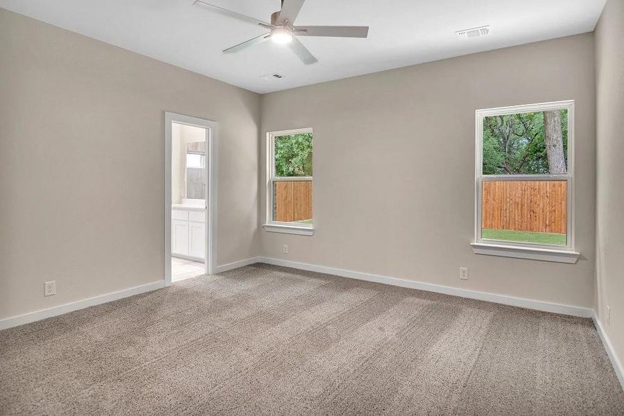 Unfurnished room featuring carpet and a ceiling fan Unfurnished room featuring carpet and a ceiling fan
