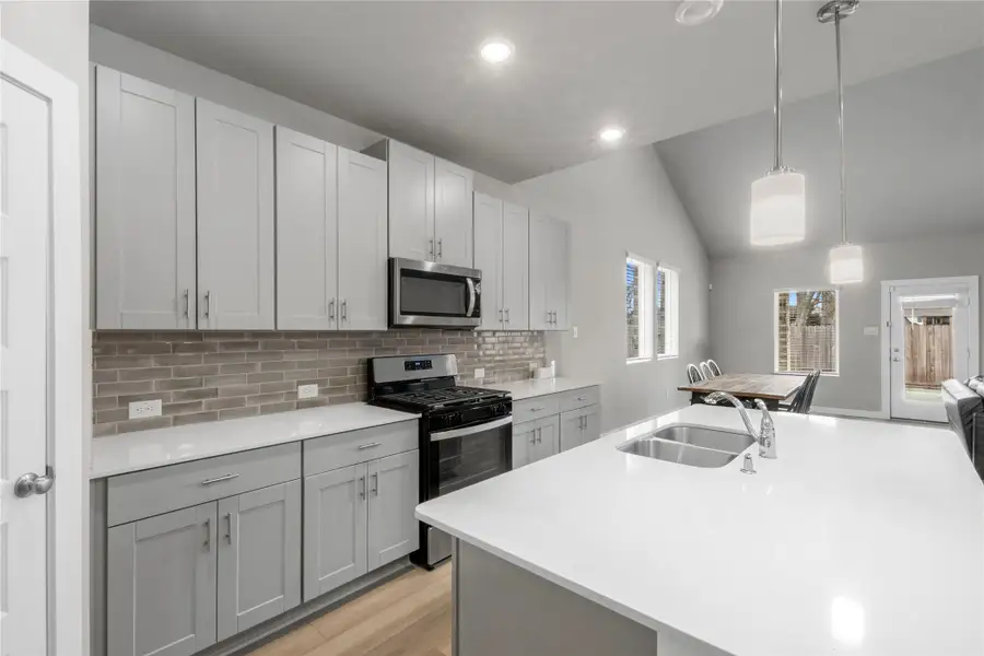 Modern and functional kitchen featuring generous counter space, ample cabinetry, and a practical layout ideal for both daily cooking and hosting guests. The kitchen seamlessly connects to the main living areas for easy interaction.