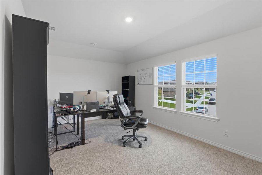 Bright room featuring two large windows with white blinds, neutral carpeting, recessed lighting, and a neutral wall color