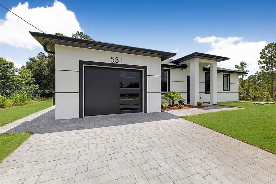 Front exterior of a new home in , Lehigh Acres, FL, highlighting curb appeal (Image 22). Front exterior of a new home in , Lehigh Acres, FL, highlighting curb appeal (Image 22).