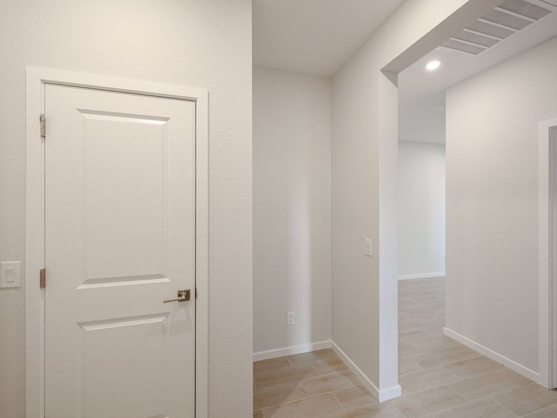 A hallway with white doors.