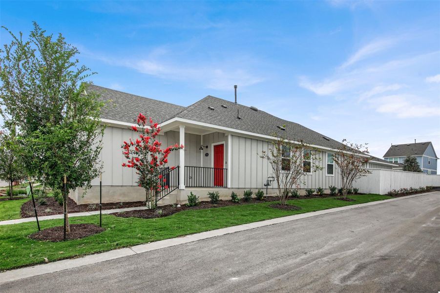 Ranch-style house featuring board and batten siding, roof with shingles, and a porch