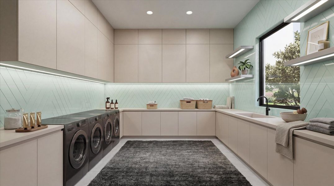 Laundry room with dual washer and dryers, along with plentiful counter and cabinet space.