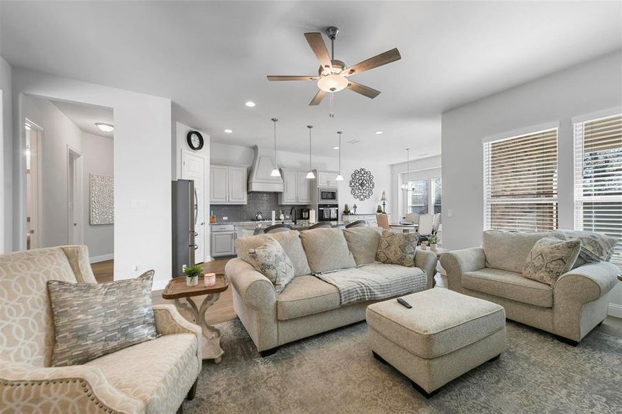 Living room featuring ceiling fan and hardwood / wood-style floors