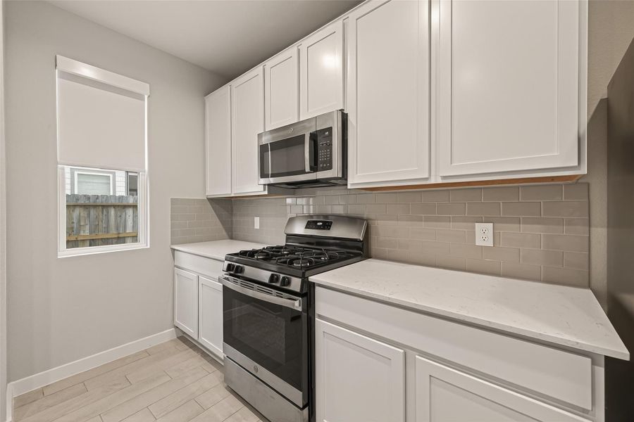 It includes ample cabinet space for storage, along with a gas range and oven for convenient cooking.