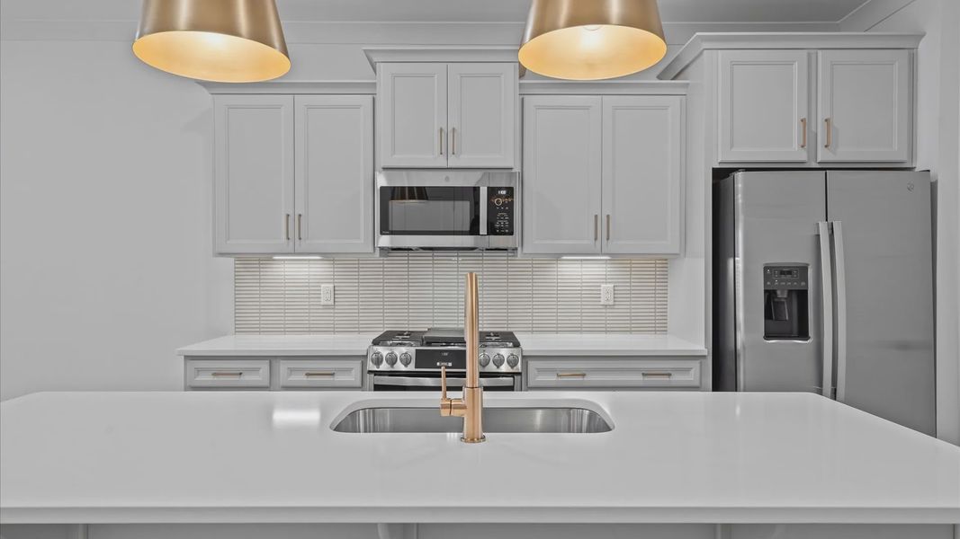 Superior kitchen with quartz countertops, pendant lighting, and a generously sized island located in Greenville, SC