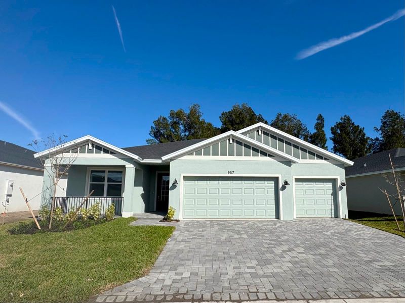 Front exterior of a new home in Hampton Park - Signature Series, Vero Beach, FL, highlighting curb appeal (Image 2). Front exterior of a new home in Hampton Park - Signature Series, Vero Beach, FL, highlighting curb appeal (Image 2).