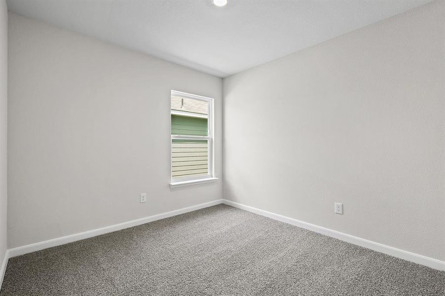 Unfurnished room featuring carpet and baseboards