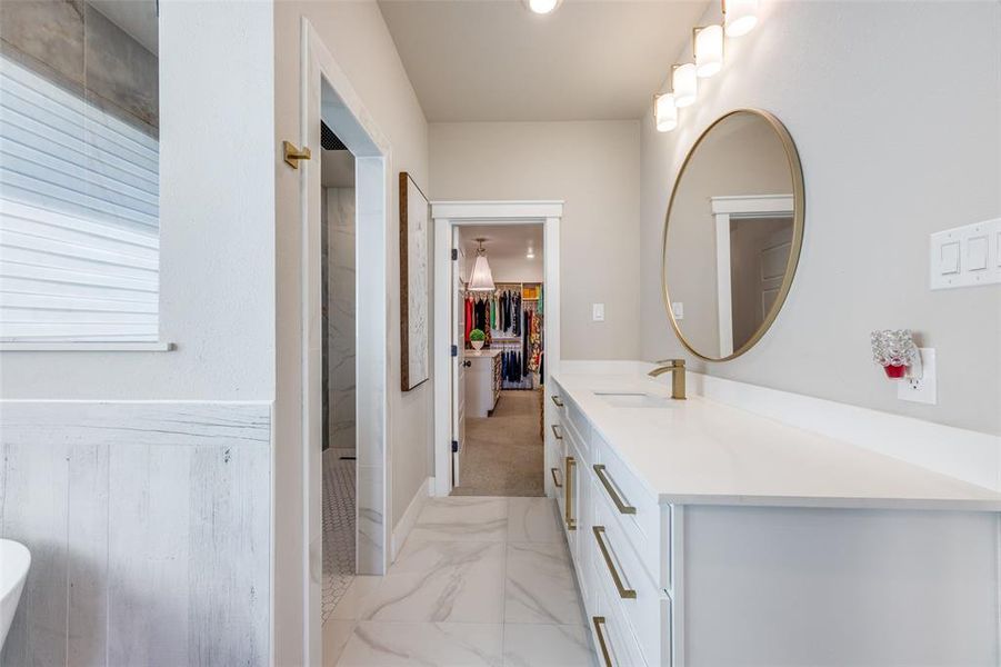 Full bath with vanity, light marble finish flooring, recessed lighting, and walk in shower
