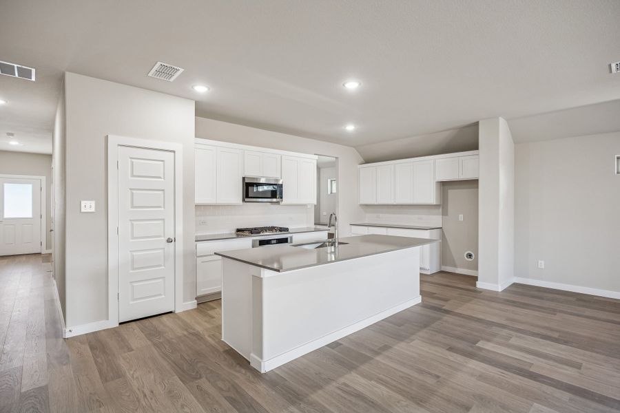 Kitchen in the Heisman home plan by Trophy Signature Homes – REPRESENTATIVE PHOTO