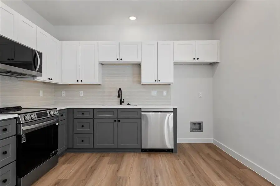 Kitchen features sleek quartz countertops, stainless steel appliances, and a modern layout designed for both style and functionality. Fridge to be added soon. Kitchen features sleek quartz countertops, stainless steel appliances, and a modern layout designed for both style and functionality. Fridge to be added soon.