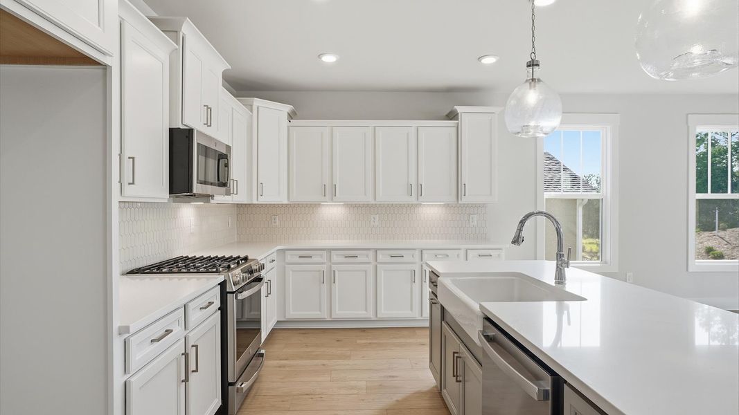 Beautifully appointed kitchen with spacious counters and sophisticated detailing at Wells Crossing