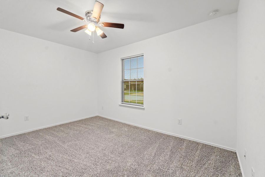 All bedrooms have brand new carpet! This primary bedroom has front yard views. All bedrooms have brand new carpet! This primary bedroom has front yard views.