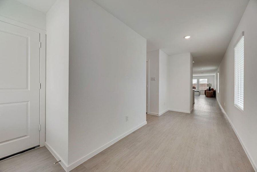 Hallway featuring light wood-type flooring and recessed lighting