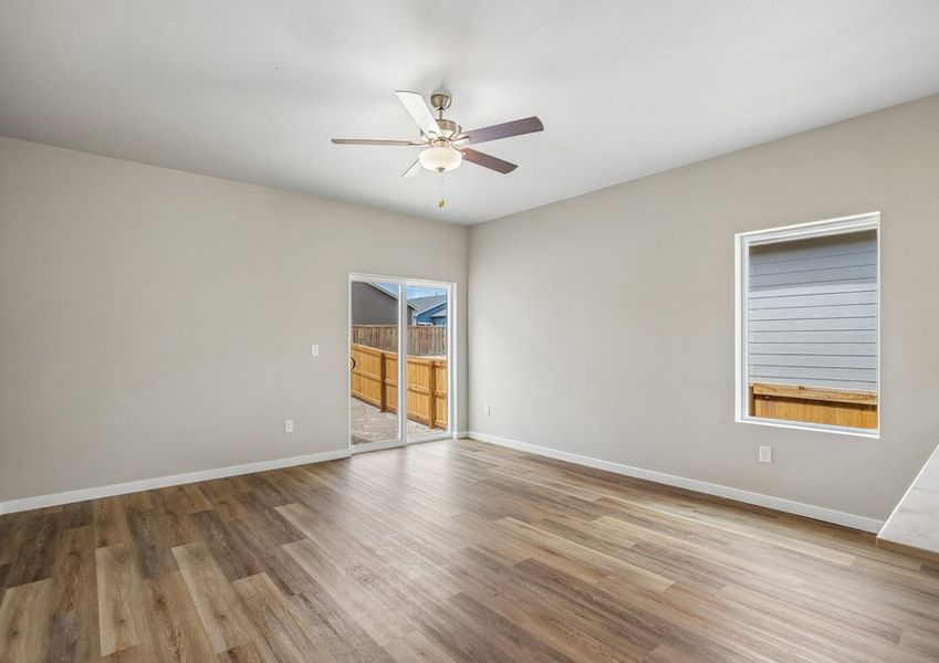 The family room is spacious with a ceiling fan.